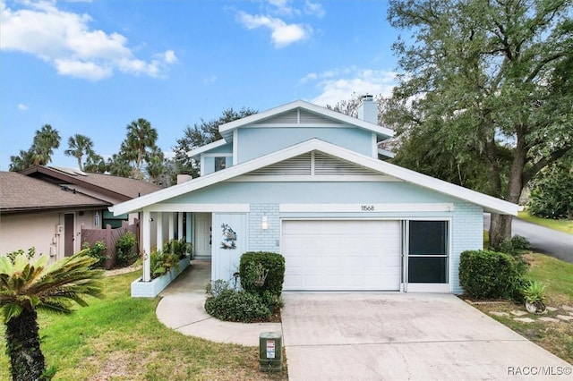 view of front of home featuring a garage and a front lawn