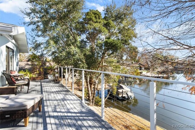 wooden terrace featuring a water view