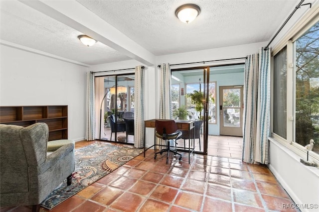 interior space with a textured ceiling and tile patterned floors