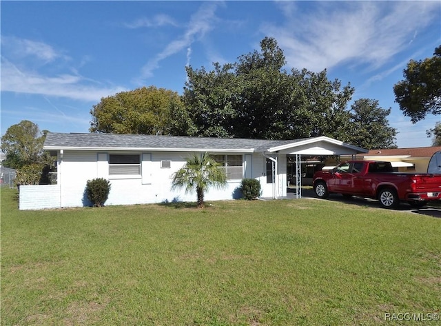 ranch-style home with a front yard and a carport