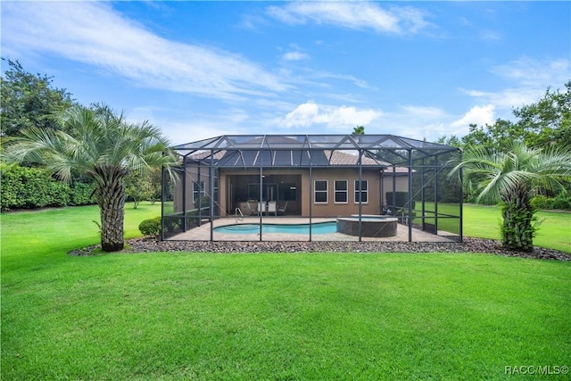 back of property with a lanai, a lawn, and a patio area