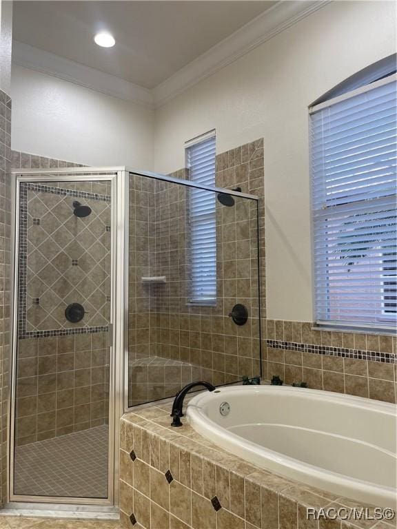 bathroom featuring crown molding and shower with separate bathtub