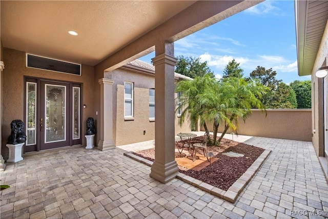 doorway to property with a patio area