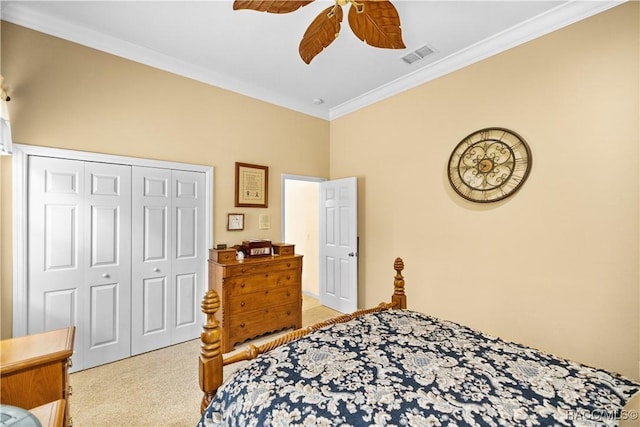 bedroom with light carpet, ceiling fan, ornamental molding, and a closet