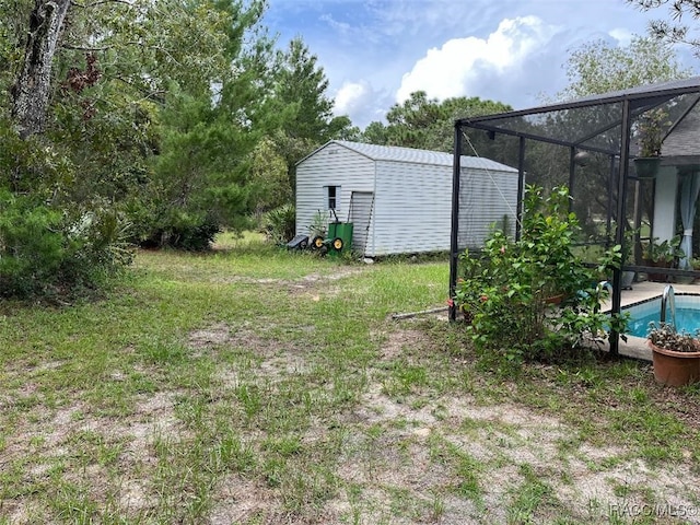 view of yard featuring a storage unit and a lanai