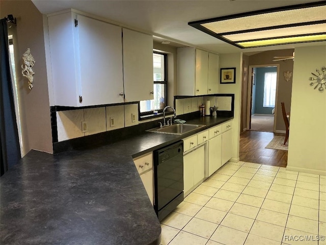 kitchen featuring dishwasher, a healthy amount of sunlight, sink, and light hardwood / wood-style flooring