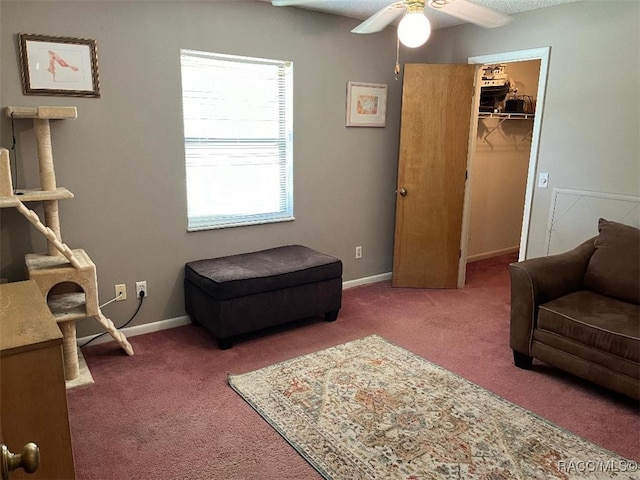 sitting room featuring carpet flooring and ceiling fan