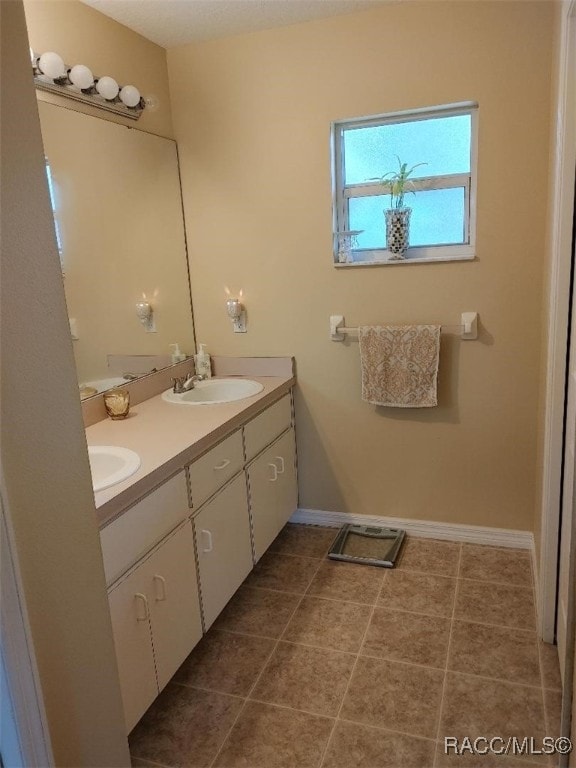 bathroom with tile patterned flooring and vanity