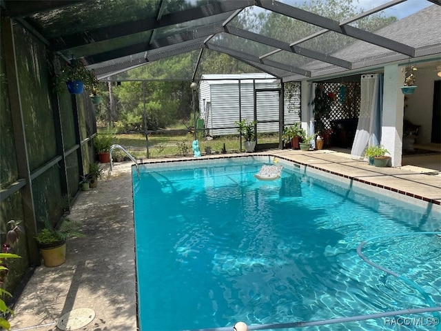 view of swimming pool featuring a lanai and a patio