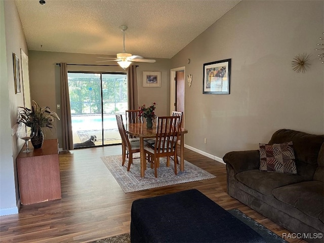 dining space featuring a textured ceiling, ceiling fan, vaulted ceiling, and hardwood / wood-style flooring