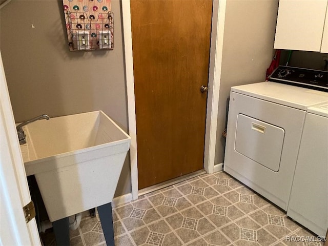 washroom with washer and clothes dryer and light tile patterned floors