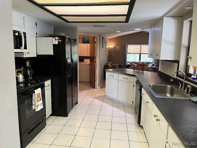 kitchen with black appliances, white cabinets, sink, and vaulted ceiling