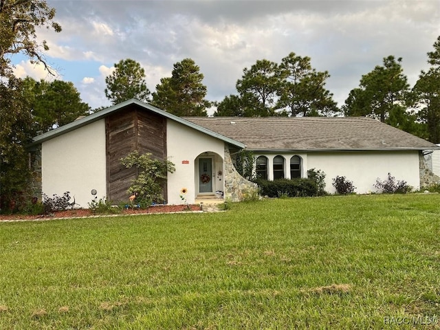 single story home with a front yard