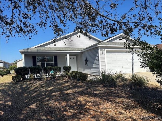 ranch-style home with an attached garage and driveway