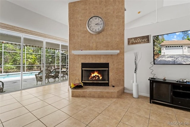 3563 W Blossom Dr, Beverly Hills, FL 34465 - living room with tile patterned flooring, high vaulted ceiling, a tiled fireplace, and baseboards