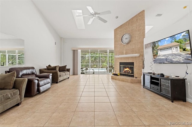 3563 W Blossom Dr, Beverly Hills, FL 34465 - living area with high vaulted ceiling, light tile patterned floors, a tiled fireplace, and a ceiling fan