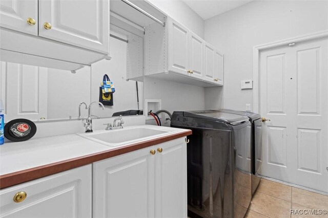 3563 W Blossom Dr, Beverly Hills, FL 34465 - laundry room with washing machine and dryer, cabinet space, and light tile patterned floors