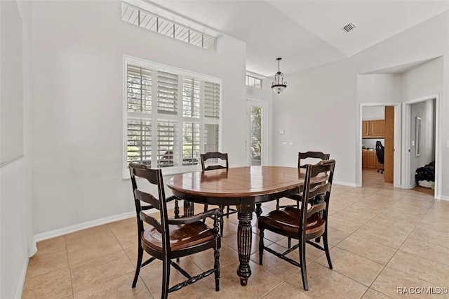 3563 W Blossom Dr, Beverly Hills, FL 34465 - dining room with light tile patterned floors, a high ceiling, and baseboards
