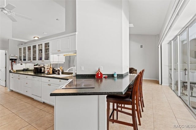 3563 W Blossom Dr, Beverly Hills, FL 34465 - kitchen with light tile patterned floors, dishwasher, a peninsula, and dark countertops