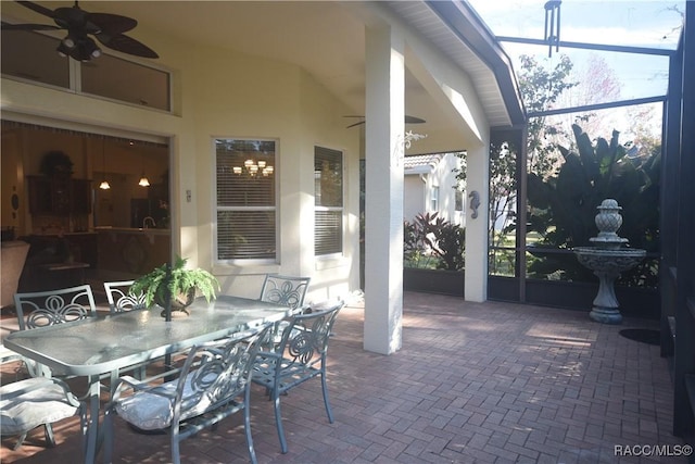 view of patio / terrace with ceiling fan and a lanai