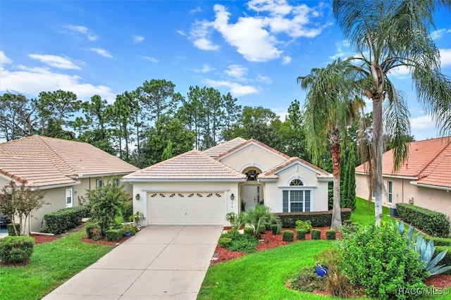 view of front of house featuring a garage and a front lawn