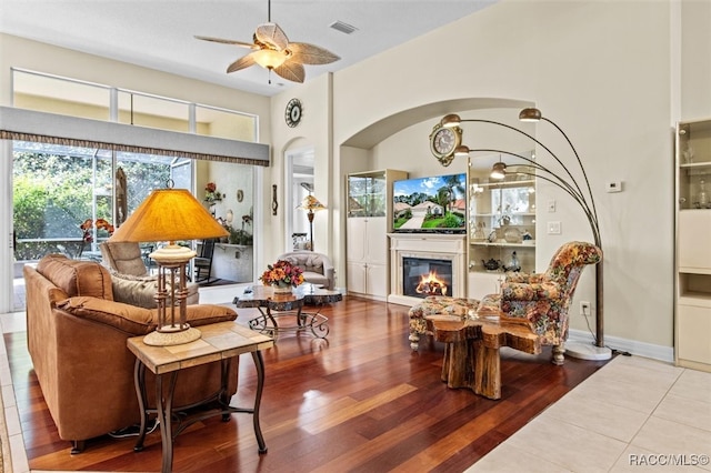 living room with ceiling fan and hardwood / wood-style flooring