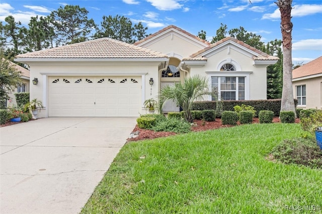 mediterranean / spanish-style house with a front yard and a garage