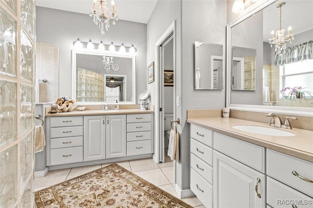 bathroom with tile patterned flooring, vanity, and a notable chandelier