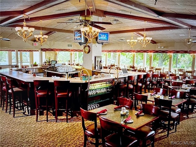 carpeted dining room with lofted ceiling with beams and an inviting chandelier