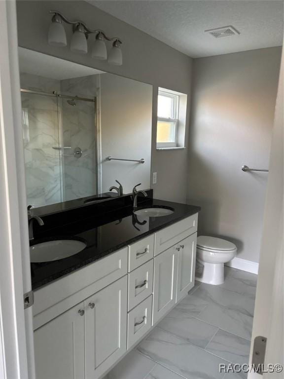 full bathroom featuring a stall shower, marble finish floor, visible vents, and a sink