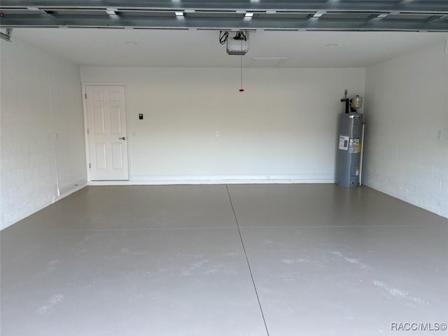 garage with a garage door opener and water heater