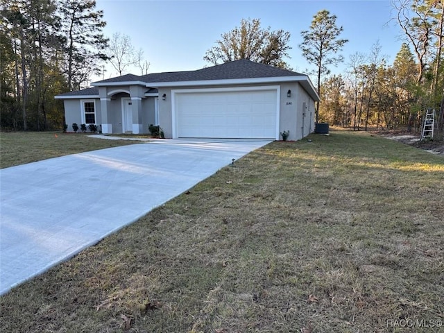 ranch-style house with a garage, driveway, a front lawn, and stucco siding