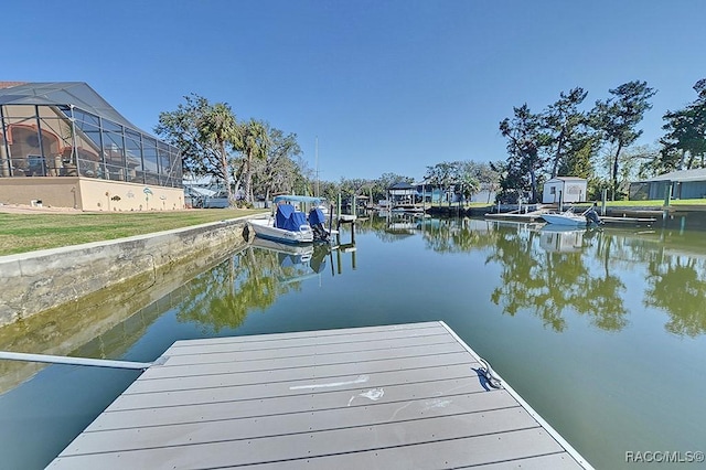 dock area with a lanai and a water view