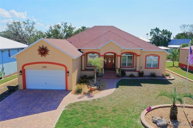 mediterranean / spanish-style house with a garage and a front yard