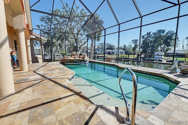 view of swimming pool with a patio, a water view, and glass enclosure