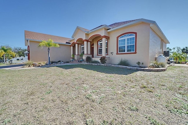 mediterranean / spanish house with a front lawn