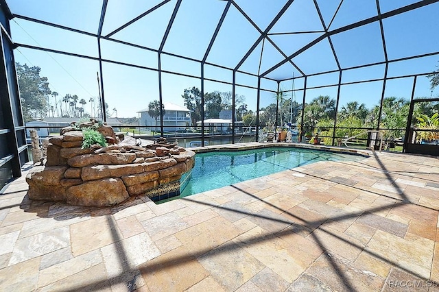 view of swimming pool featuring glass enclosure and a patio area