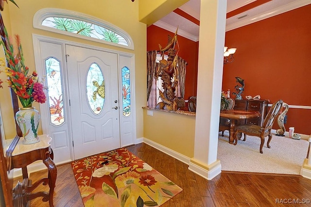 entryway featuring crown molding and dark hardwood / wood-style floors