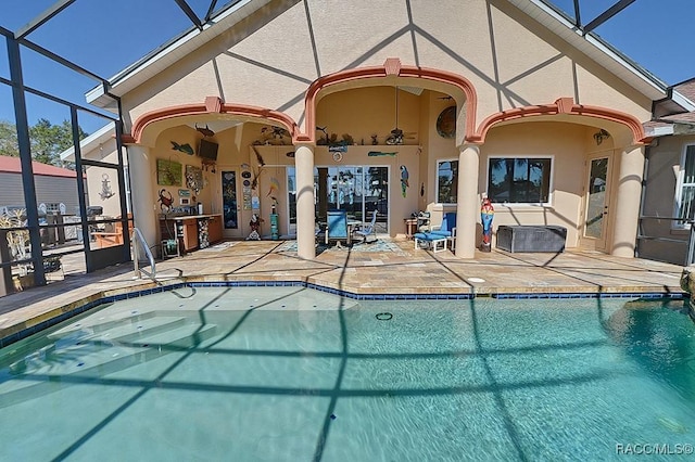 view of pool with a lanai, ceiling fan, and a patio area