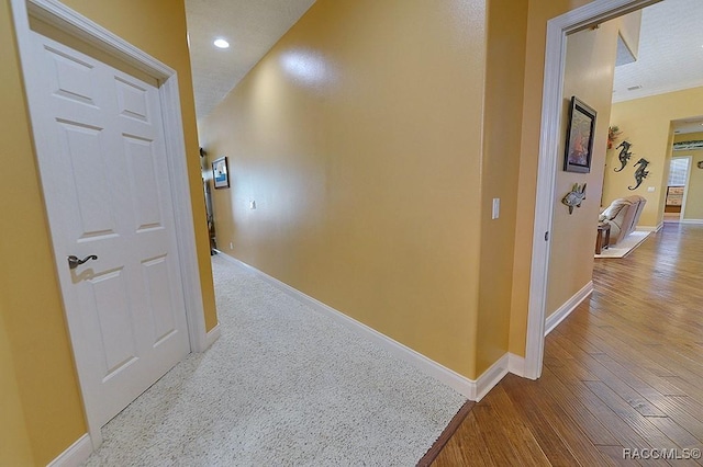 hallway with hardwood / wood-style flooring