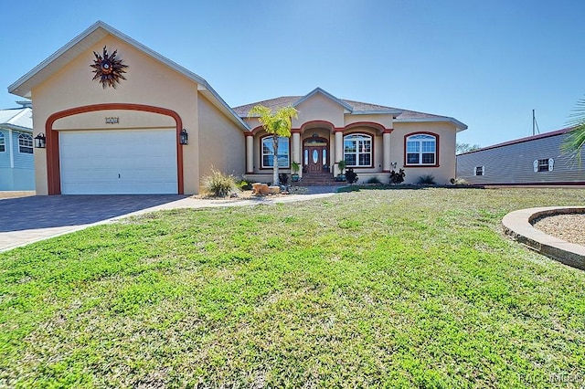 view of front of home with a garage and a front lawn