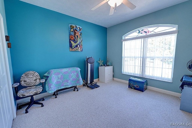 interior space featuring ceiling fan and a textured ceiling