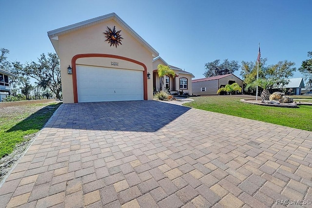 ranch-style home featuring a garage and a front yard