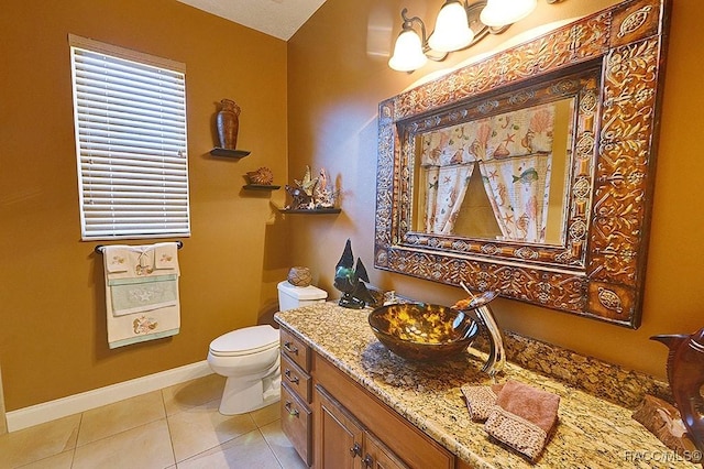 bathroom with tile patterned flooring, vanity, and toilet