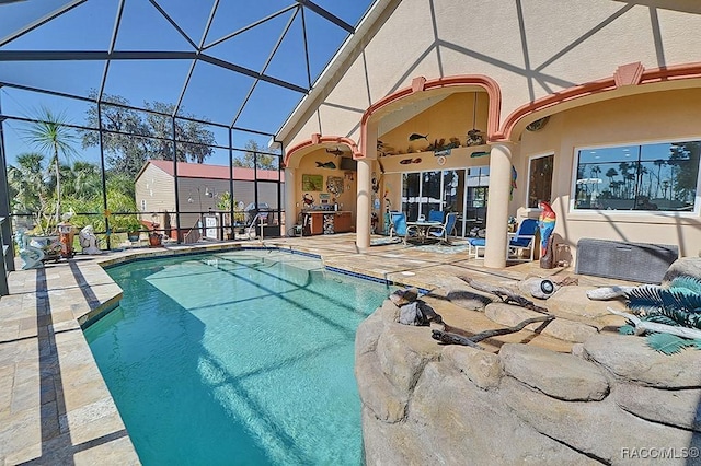 view of swimming pool featuring a patio area, ceiling fan, and glass enclosure