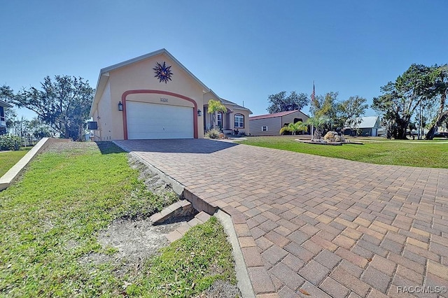 ranch-style home featuring a garage and a front yard