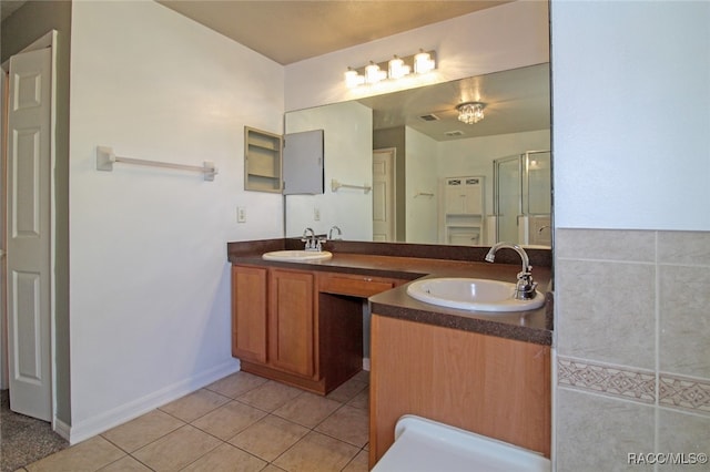 bathroom featuring tile patterned flooring and vanity