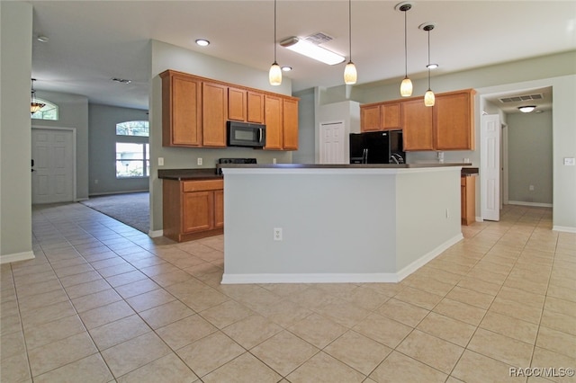 kitchen featuring light tile patterned floors, a kitchen island, black appliances, and decorative light fixtures