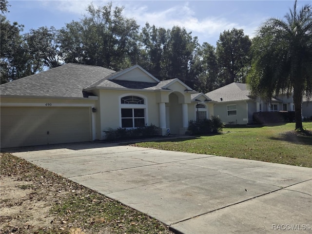 ranch-style home with a front lawn and a garage