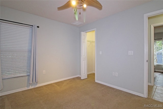 empty room featuring light colored carpet and ceiling fan